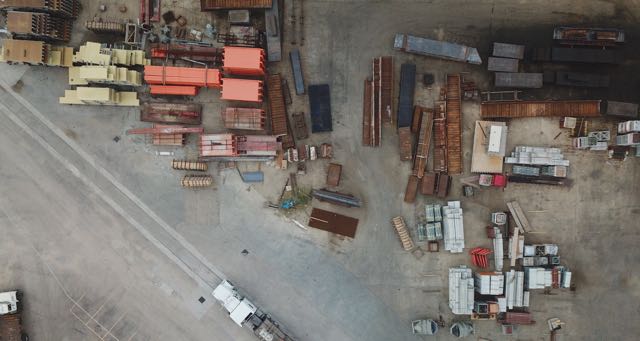 industrial construction site with trucks and shipping containers