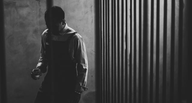 man holding a candle in stairs